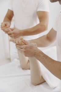 Close-up of a masseur giving a professional hand massage to a client in a serene setting.